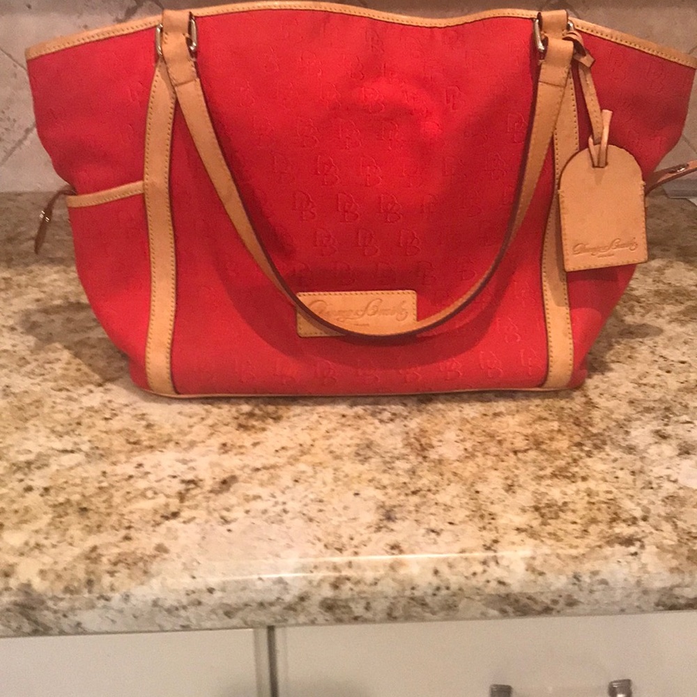 Large Dooney and Bourke satchel with side pockets in a vibrant red